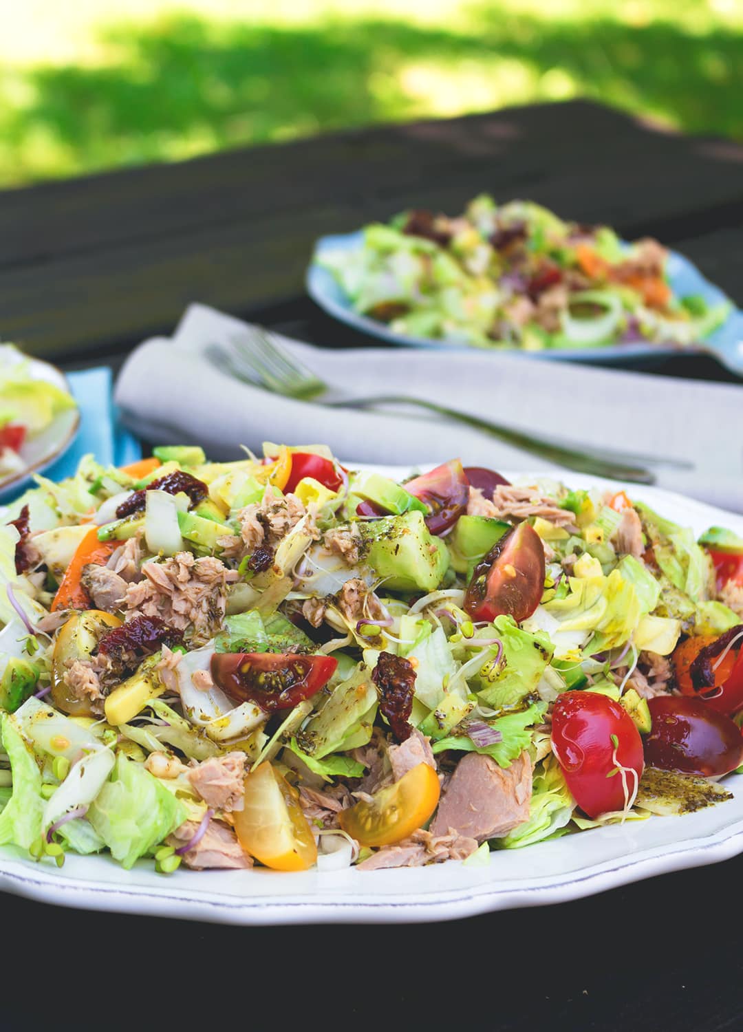 Colorful Salad with Tuna and Sundried Tomatoes - delicious easy every day summer lunch. A few ingredients include lettuce, cherry tomatoes, cucumber, avocado, and dressing. Great as packed lunch! | thehealthfulideas.com