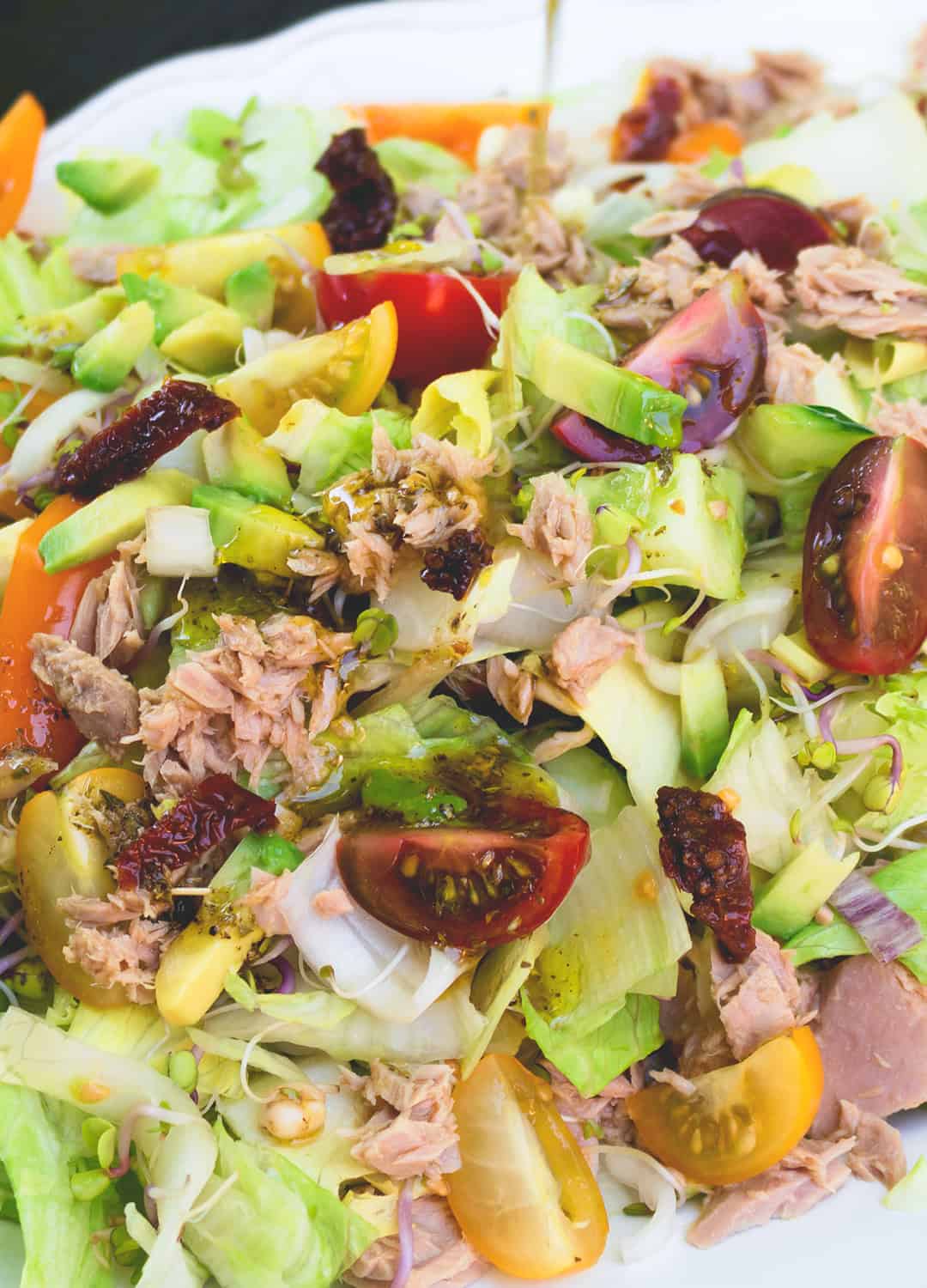 Colorful Salad with Tuna and Sundried Tomatoes - delicious easy every day summer lunch. A few ingredients include lettuce, cherry tomatoes, cucumber, avocado, and dressing. Great as packed lunch! | thehealthfulideas.com