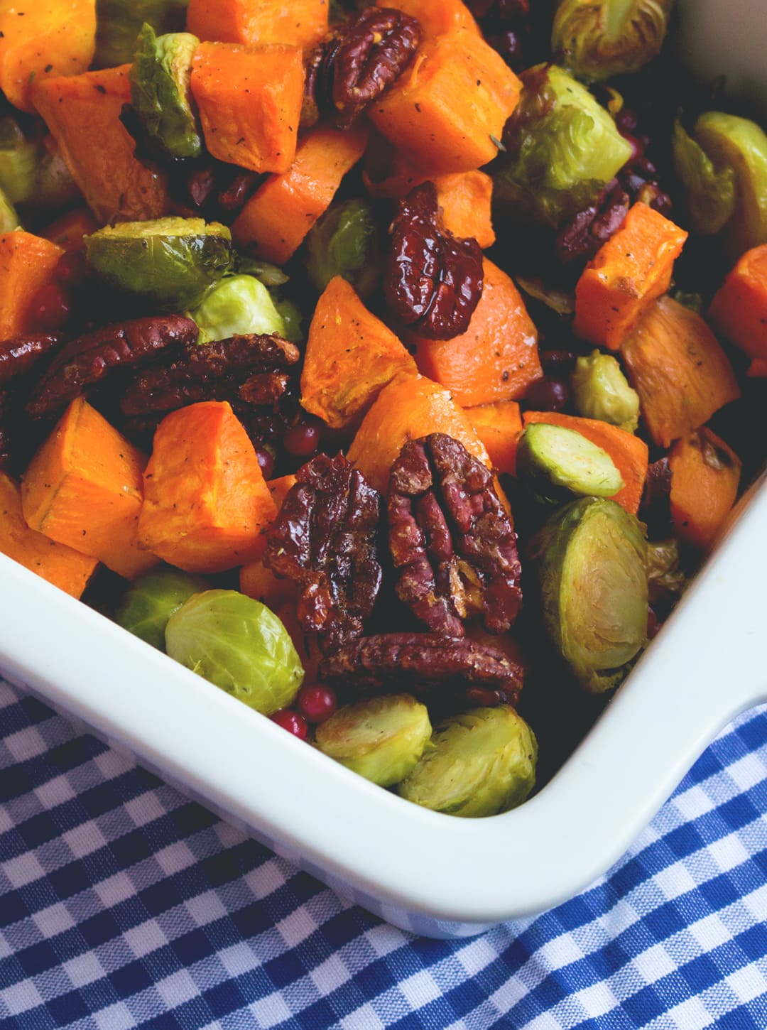 Roasted Sweet Potatoes and Brussels Sprouts with Maple Drizzle - delicious side dish, great all year round! I absolutely love this recipe. It's sweet, savory, tangy, nutty, hearty, and vegan and healthy! | thehealthfulideas.com