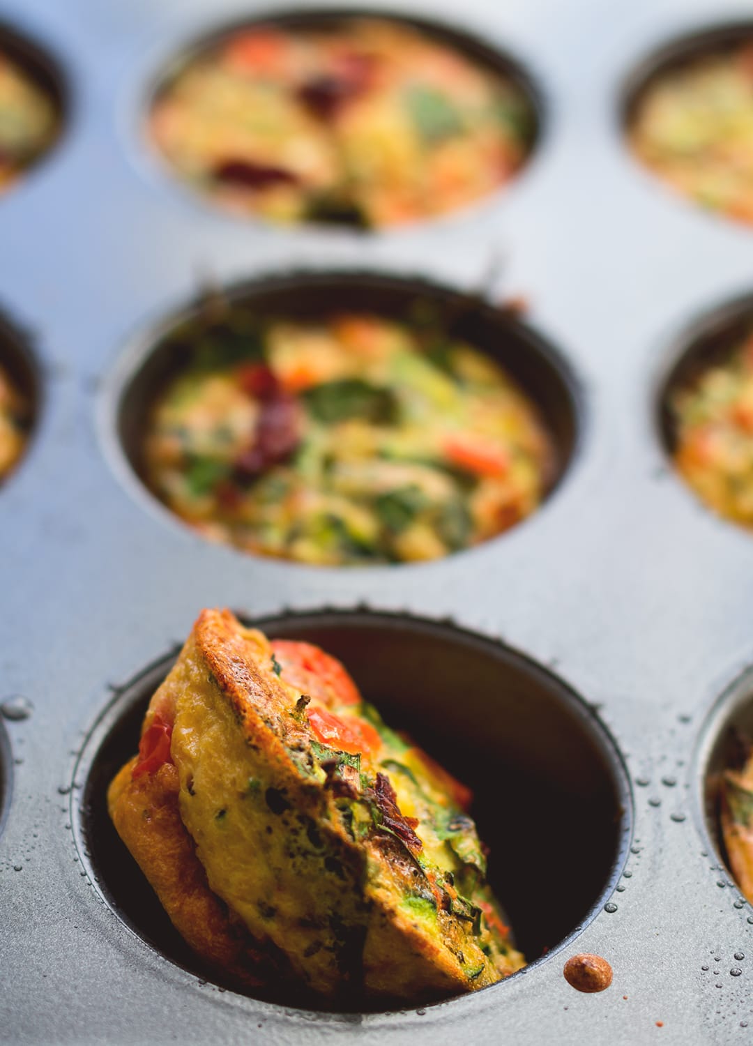 Healthy Breakfast Cheesy Egg Muffins - easy breakfast you can make ahead and eat on the go! Keep them in the fridge and add one or two to your salad for more protein! Delicious and cheesy muffins without the use of cheese - these are dairy free! | thehealthfulideas.com