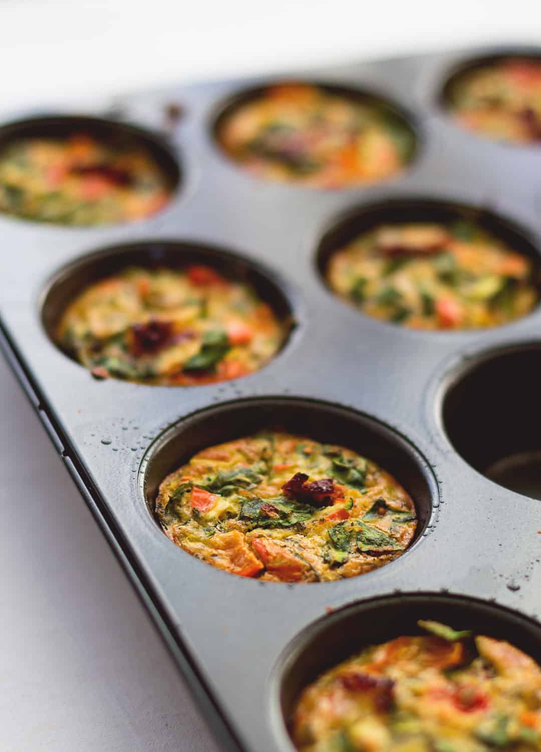 Healthy Breakfast Cheesy Egg Muffins - easy breakfast you can make ahead and eat on the go! Keep them in the fridge and add one or two to your salad for more protein! Delicious and cheesy muffins without the use of cheese - these are dairy free! | thehealthfulideas.com