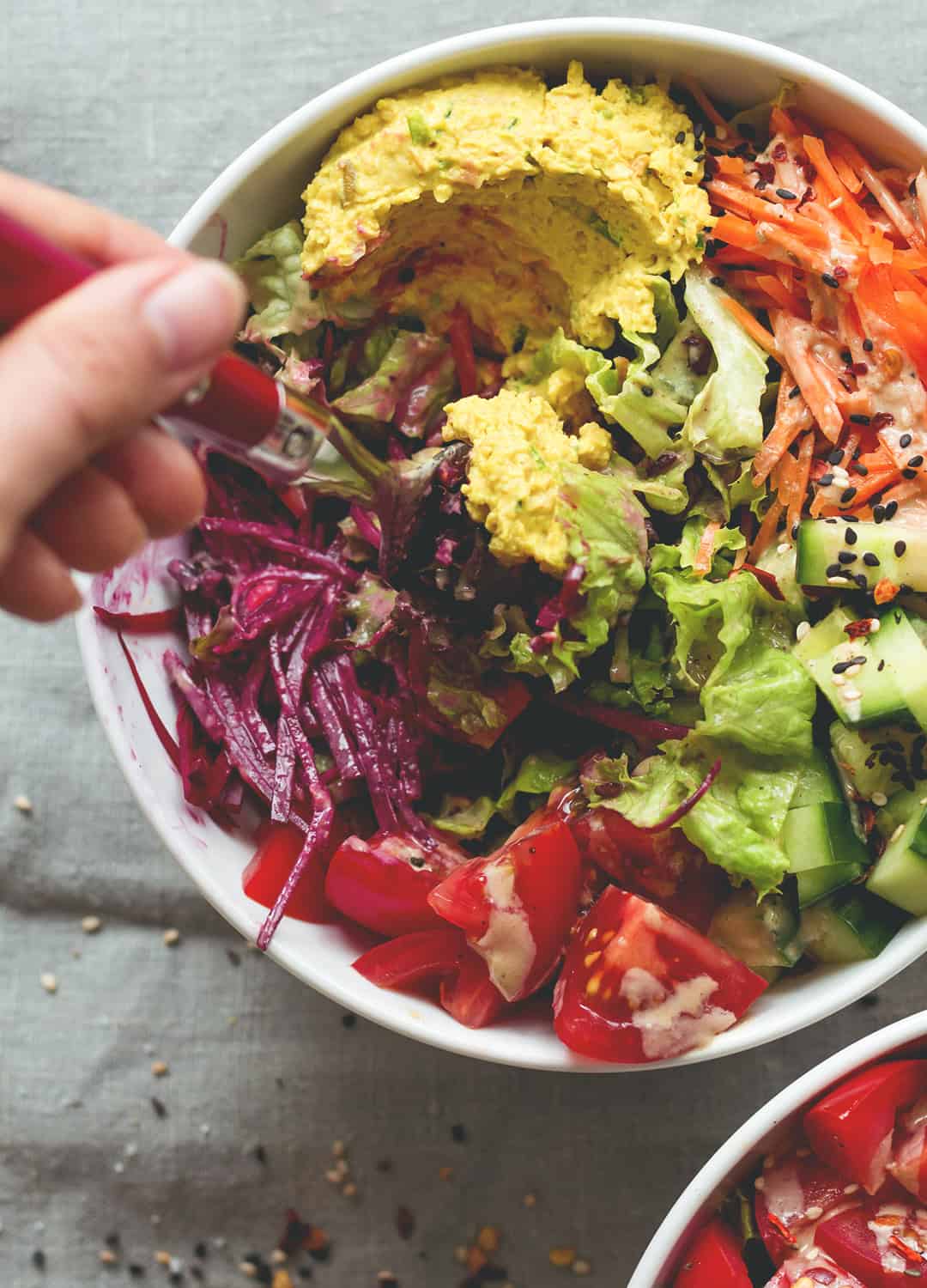 Black Rice Salad Bowl with Tahini Dressing - easy to make fresh summer salad. I love to make this ahead for busy work days! Tomatoes, cucumber, beets, carrots, hummus, lettuce, black rice, and tahini dressing. (vegan, GF) | thehealthfulideas.com