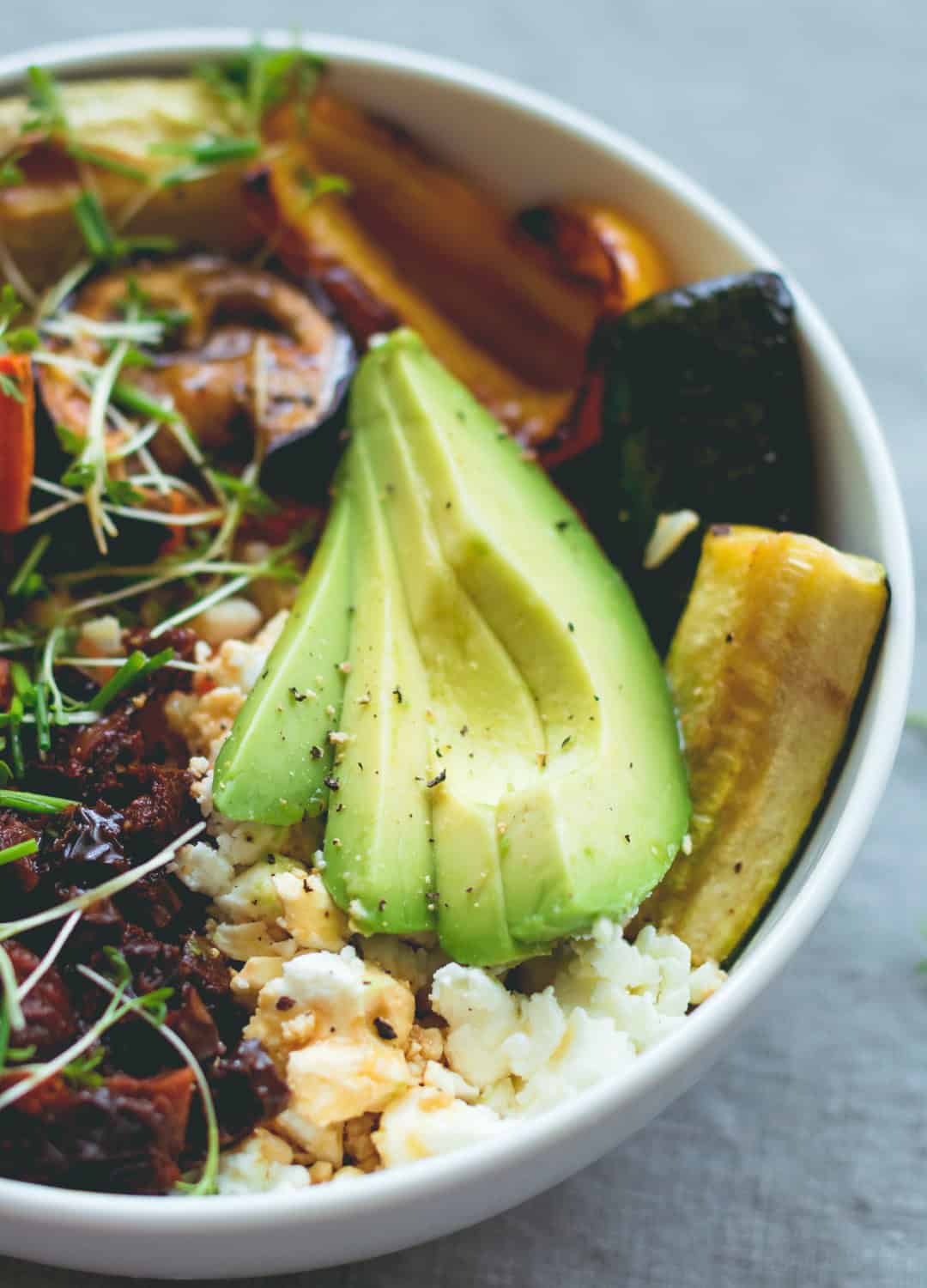 Brown Rice Salad Bowl with Roasted Veggies & Tamari Dressing - not your average boring salad! Roasted veggies, sweet potatoes, brown rice, lettuce, sundried tomatoes, goats cheese, and avocado with sweet & sour tamari dressing. Easy to make and absolutely scrumptious! | thehealthfulideas.com