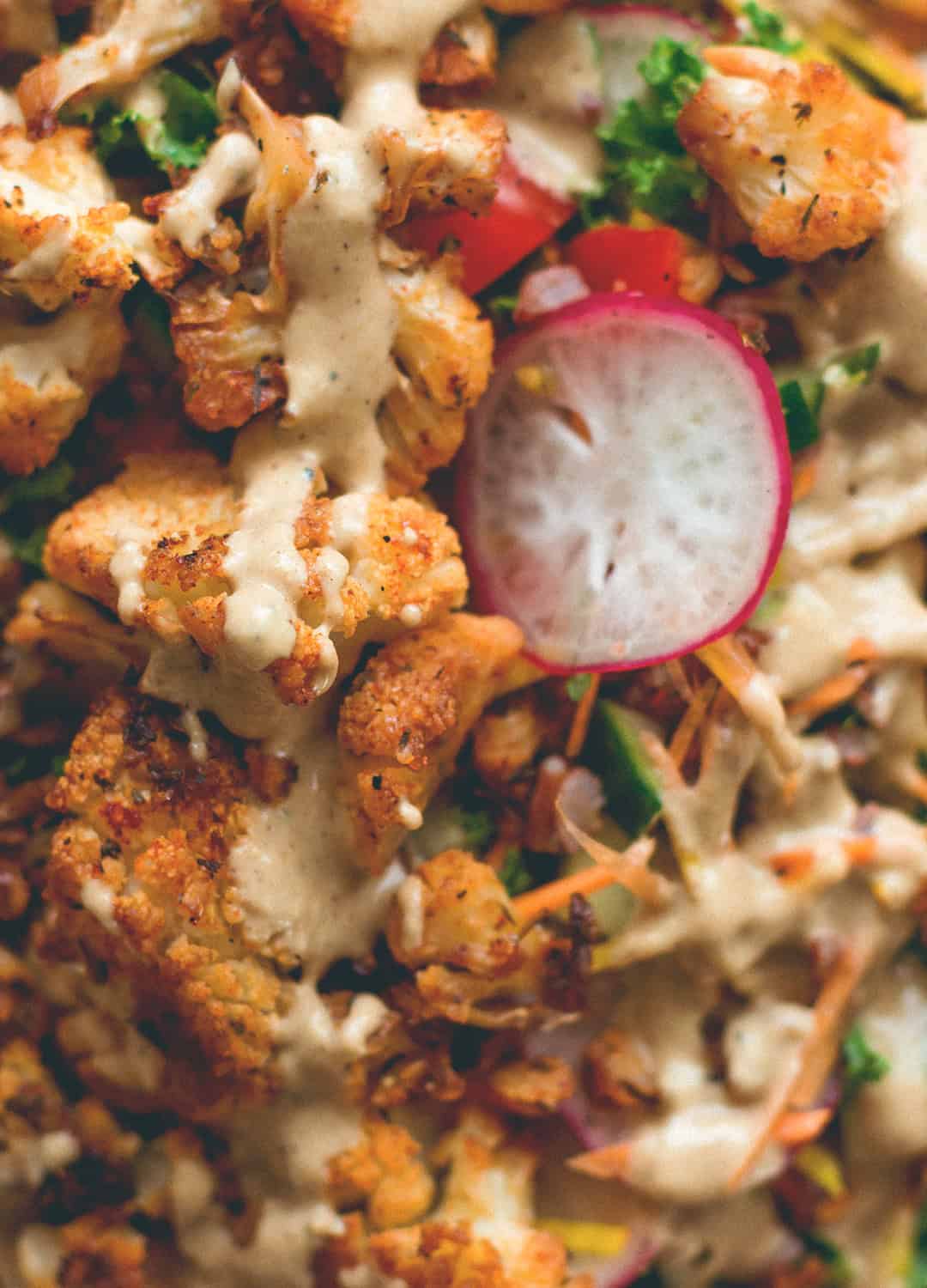 Cajun Roasted Cauliflower Salad - I love cajun seasoning on roasted fall vegetables. This salad is perfect for this time of the year. Cauliflower, mixed salad, and tahini dressing. (vegan, GF) | thehealthfulideas.com