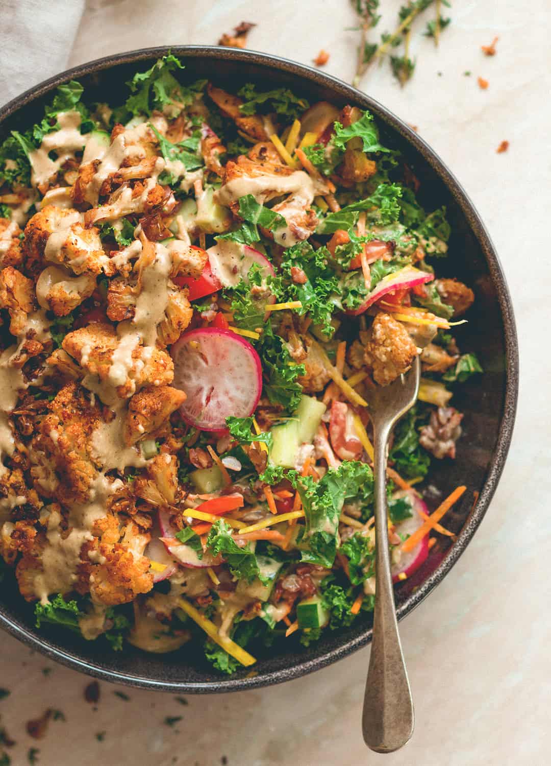 Cajun Roasted Cauliflower Salad - I love cajun seasoning on roasted fall vegetables. This salad is perfect for this time of the year. Cauliflower, mixed salad, and tahini dressing. (vegan, GF) | thehealthfulideas.com