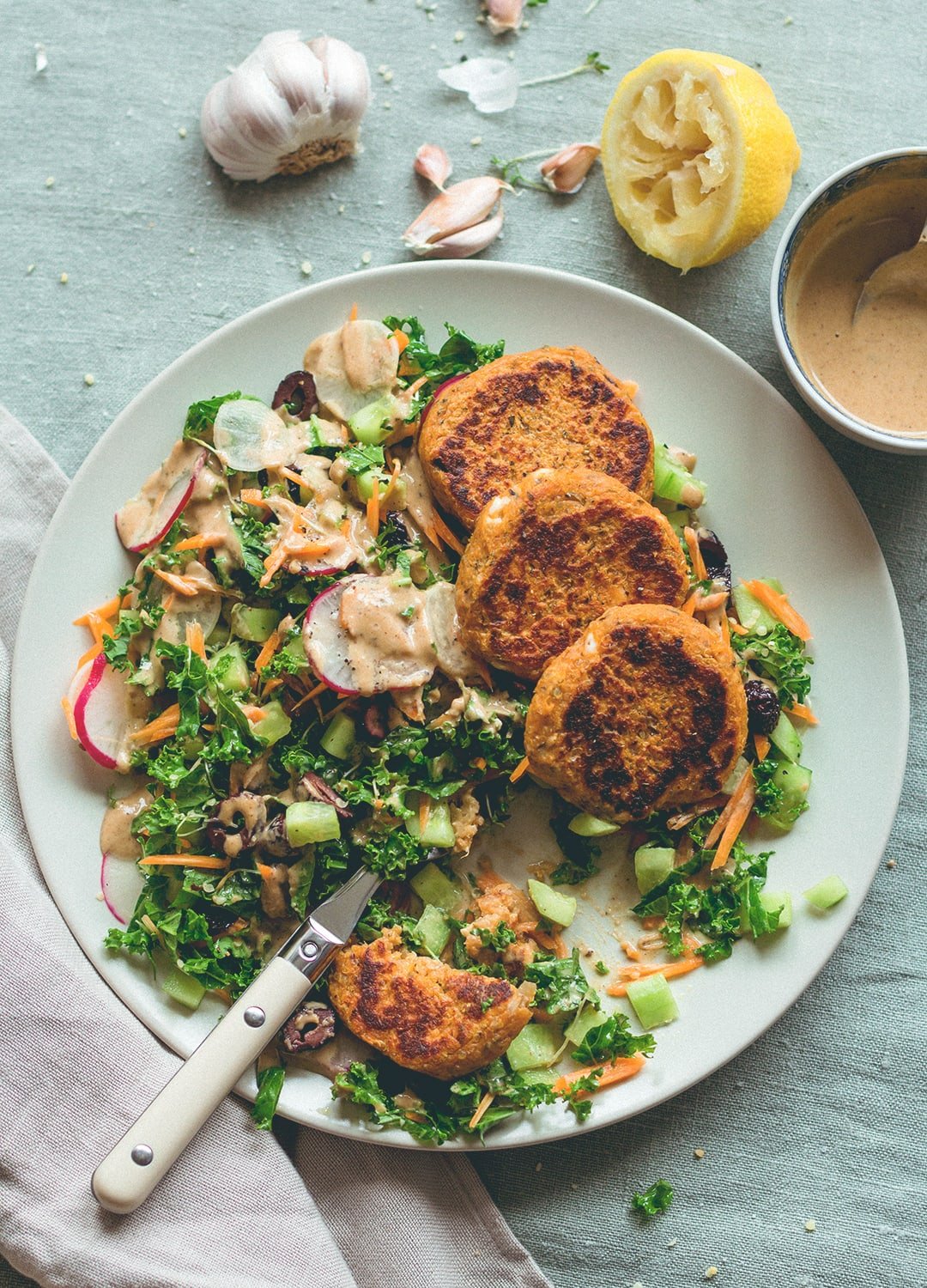Sweet Potato Quinoa Patties with mixed salad and tahini dressing. This recipe is vegan, gluten-free, and totally amazing! You'll love it. | thehealthfulideas.com