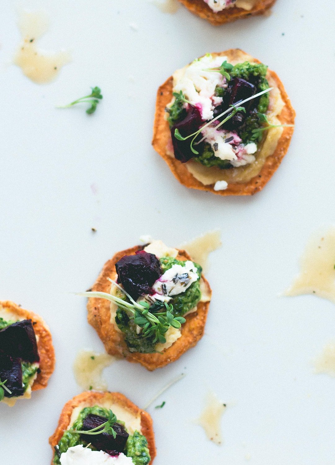 Sweet Potato Rounds with Hummus, Arugula Basil Pesto, Goat Cheese, Roasted Beets, Sprouts, and a drizzle of honey. Can be made vegan too! Gluten-free. | thehealthfulideas.com