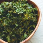 Onion Kale Chips - made in the oven in under 30 minutes! Easy & delicious these kale chips are the perfect movie night snack or anytime you're craving something salty & crunchy. | thehealthfulideas.com