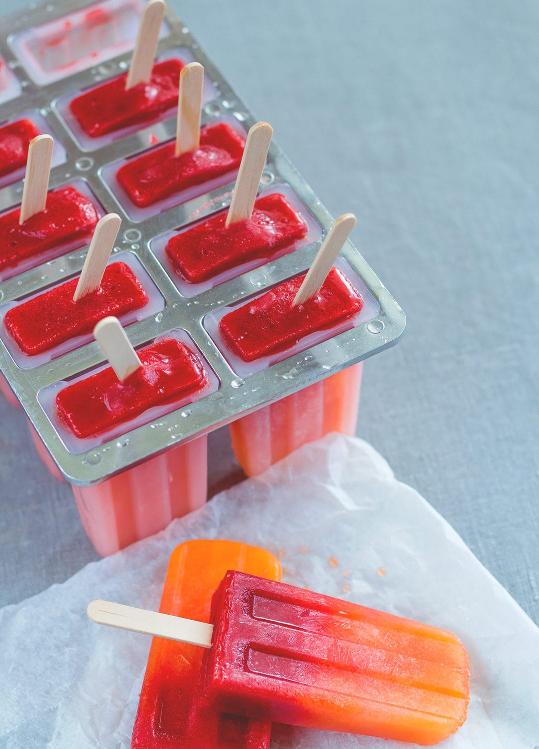 Orange Strawberry Sunrise Popsicles - treat yourself with homemade popsicles this summer. We LOVE these! They're easy to make, delicious, and actually healthy! (raw vegan) | thehealthfulideas.com