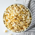 The Best Vegan Popcorn - a delicious blend of nutritional yeast, garlic, onion powder, and other spices sprinkled over popcorn made with avocado oil.