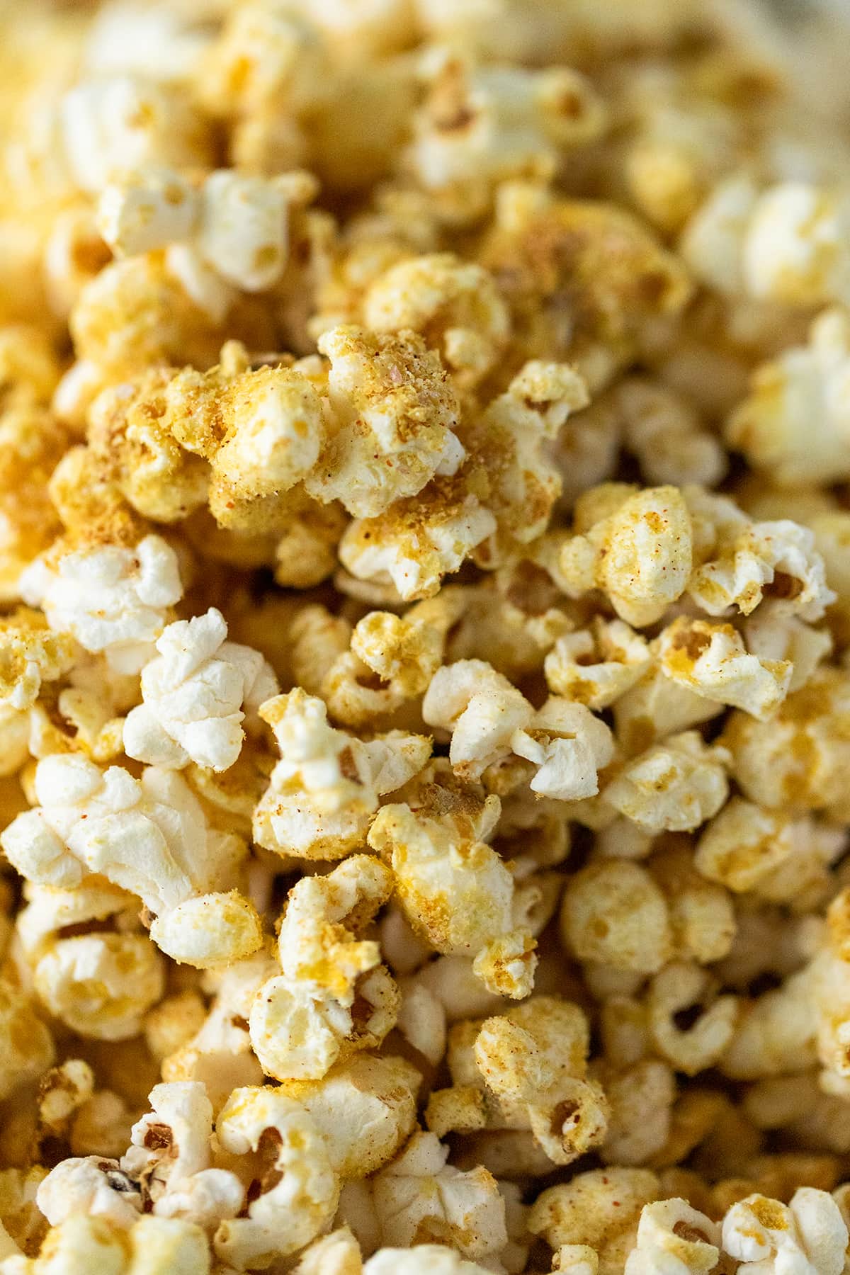 The Best Vegan Popcorn - a delicious blend of nutritional yeast, garlic, onion powder, and other spices sprinkled over popcorn made with avocado oil.