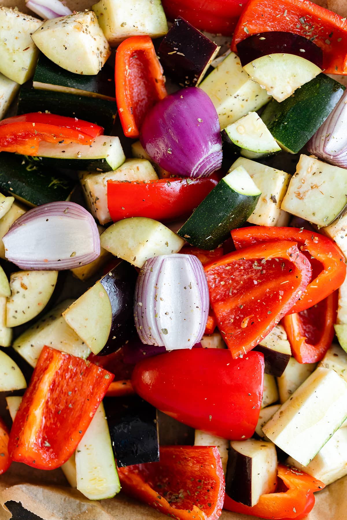 Chopped mixed vegetables with dried herbs - red onion, eggplant, zucchini, and red bell pepper