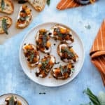 A square photo of Butternut Squash Crostini with Goat Cheese and Fig Balsamic Glaze