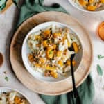 A vertical overhead shot of Butternut Squash Penne with Sage and Toasted Walnuts on a white plate