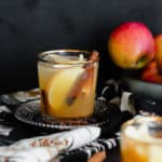 A straight on photo of Spiced Rum Apple Cider Cocktail in a short glass with a golden rim