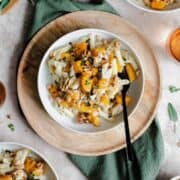 A vertical overhead shot of Butternut Squash Penne with Sage and Toasted Walnuts on a white plate