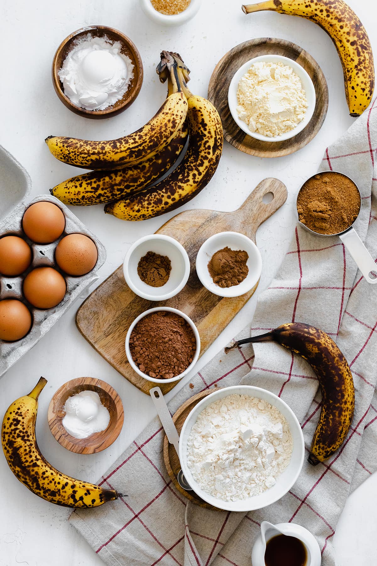 Ingredients for the Caramelized Chocolate Banana Bread laid out on a white table
