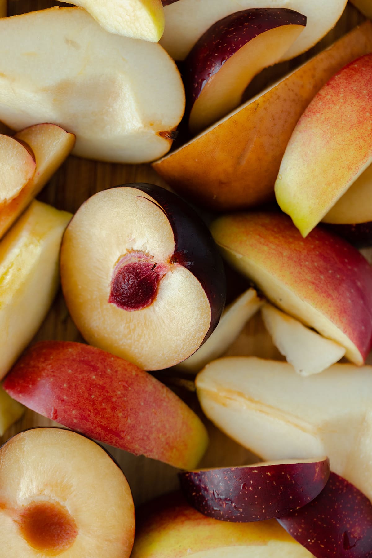 Seasonal winter fruits. Pears, apples, and stone fruit chopped.