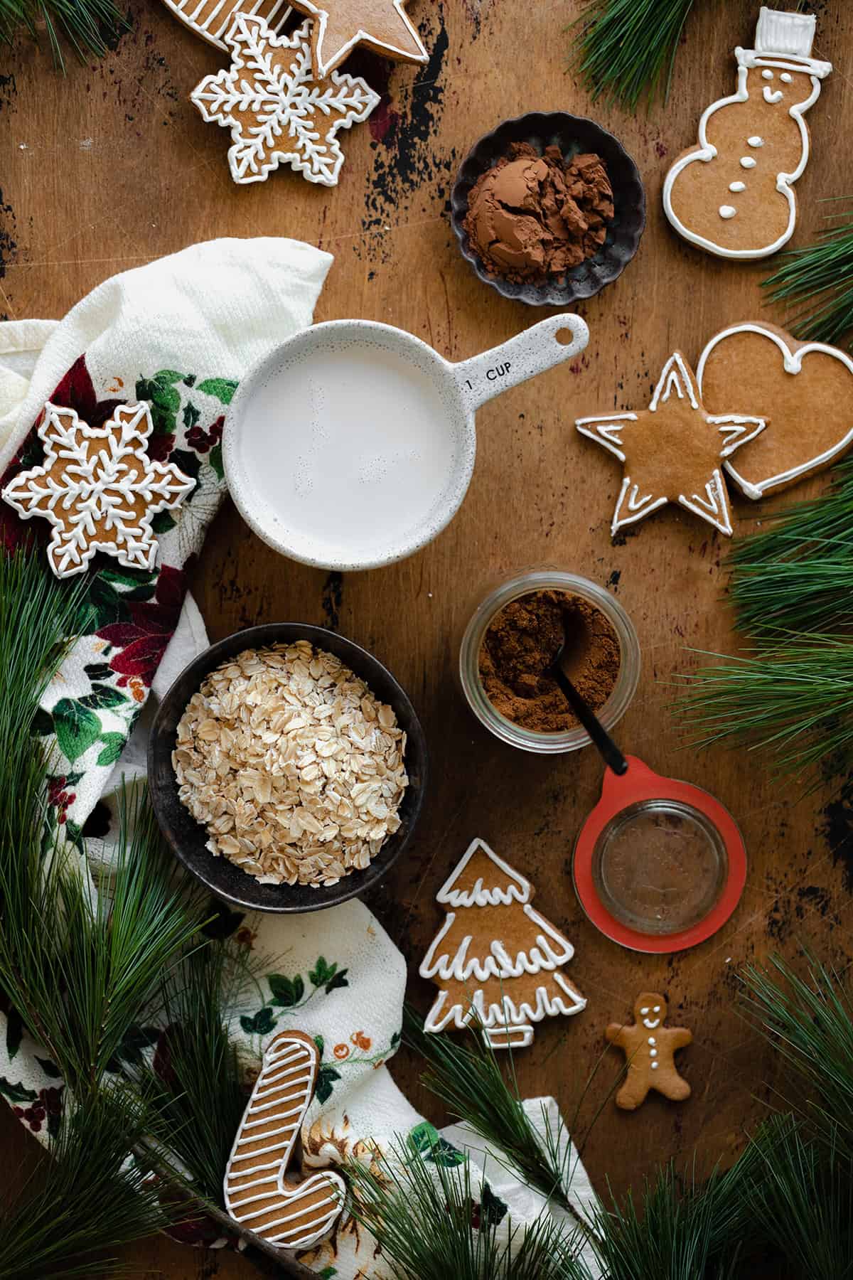 Ingredients for gingerbread oatmeal laid out on a light wooden background.