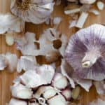 An overhead shot of garlic bulbs with the top cut off