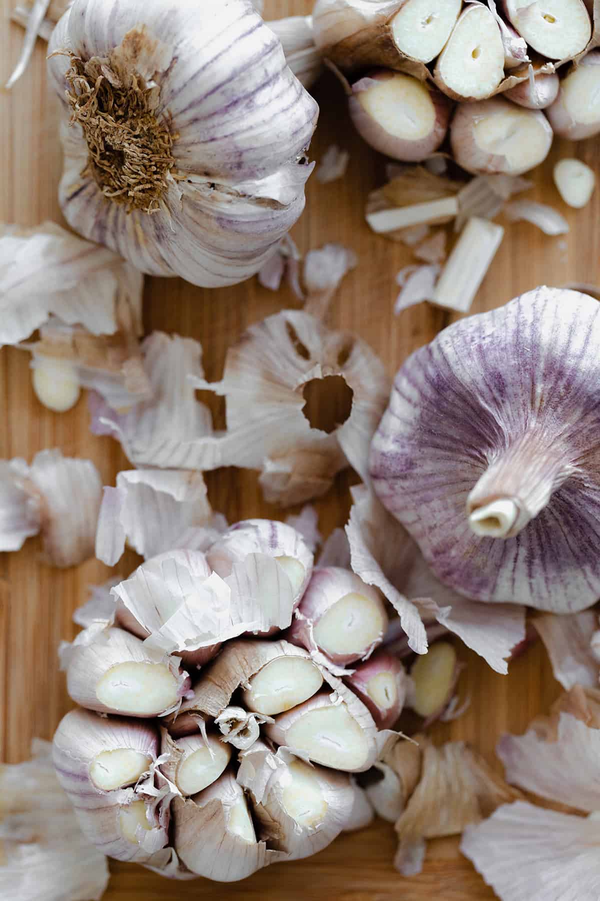 An overhead shot of garlic bulbs with the top cut off