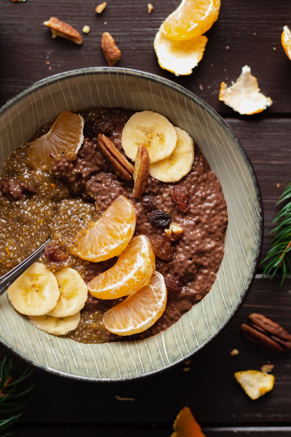 Tangerine Chocolate Chia Pudding in a bowl on a dark wooden table.