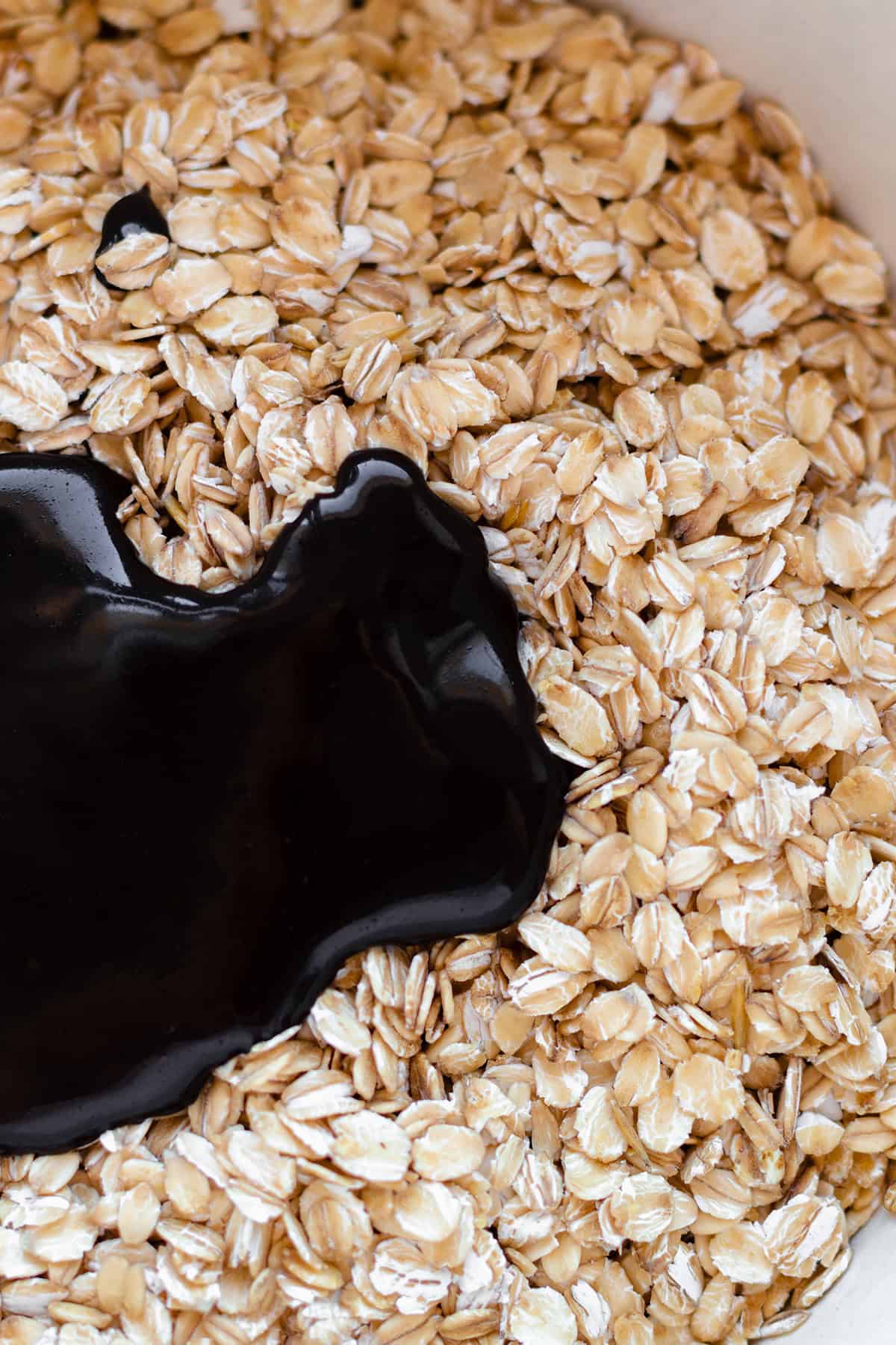 A close up of a bowl with oats and a carob maple syrup and coconut mixture.