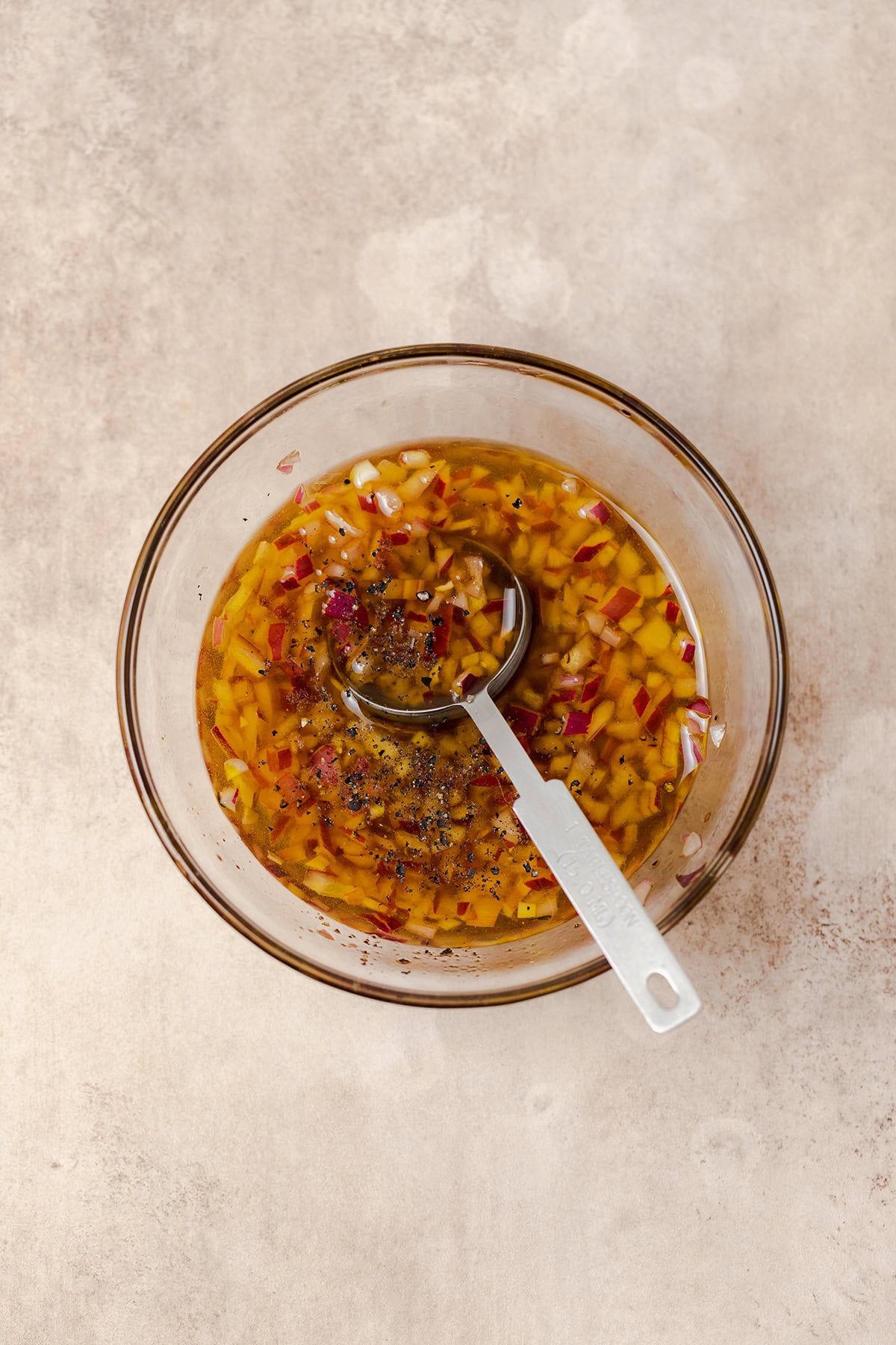 Sherry vinaigrette with shallot in a small glass bowl.