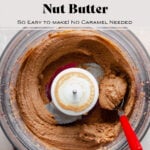 Salted Caramel Nut butter in a food processor with a red spoon on the right.