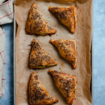 Spinach and Feta Triangles on a baking sheet lined with parchment paper.