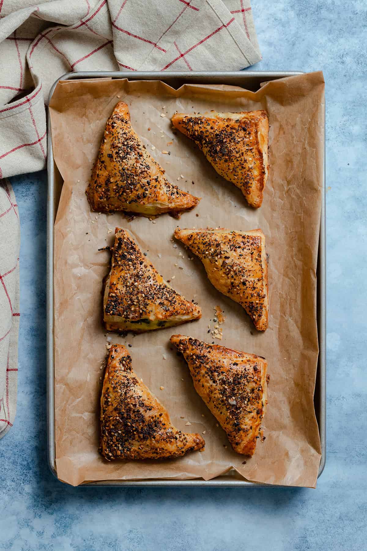 Spinach Triangles on a baking sheet lined with parchment paper.