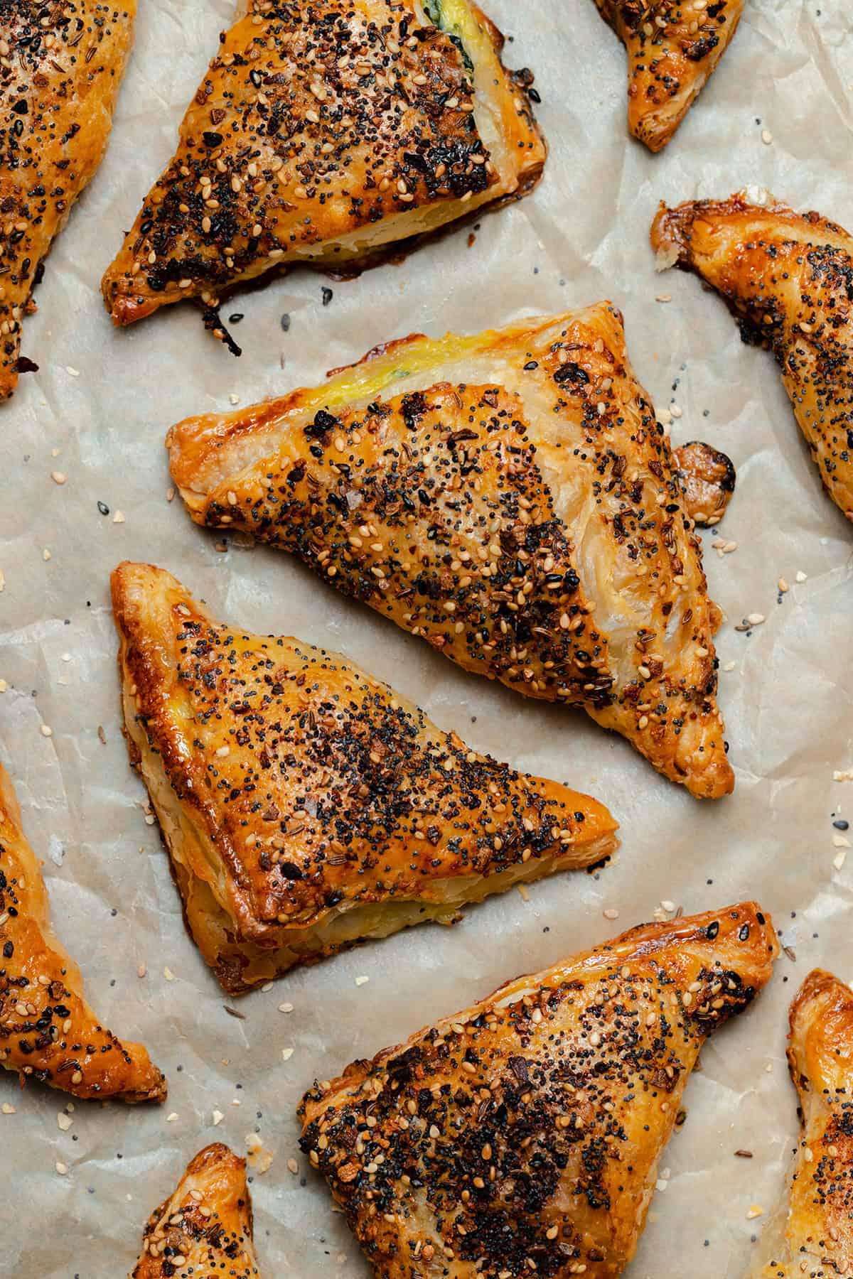 Crispy golden puff pastry triangles on parchment paper.