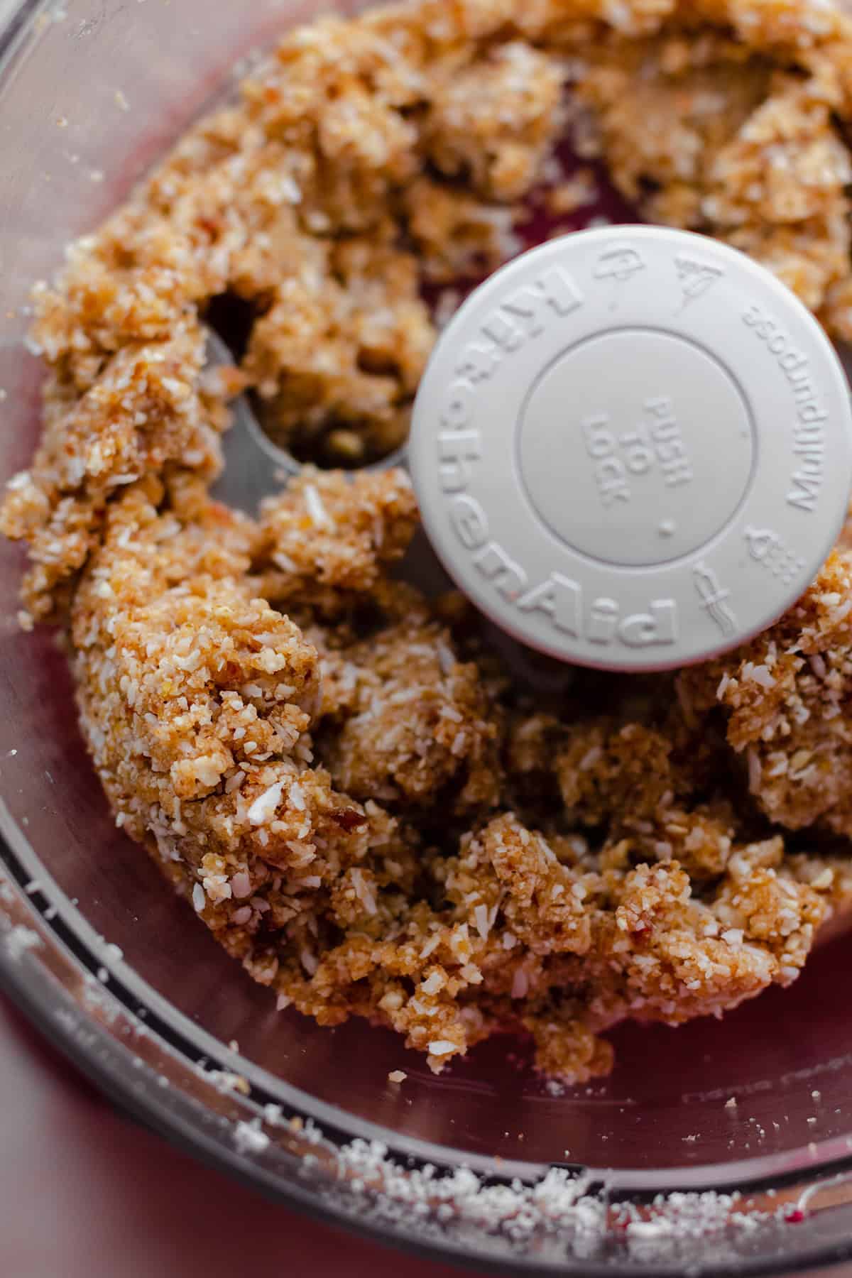 A process shot of energy balls. All ingredients in a food processor. Processed into a crumble.