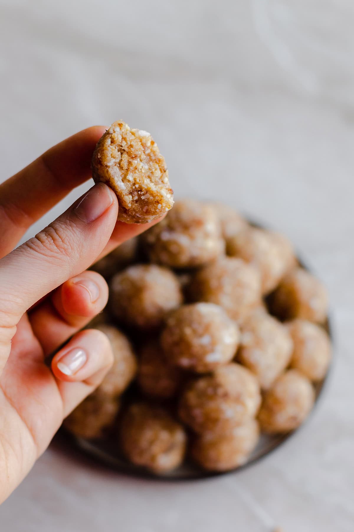 A left hand on the left side of the frame holding one of the energy balls. With a birte taken out of the ball.