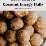 Coconut Energy Balls stacked up on a plate. Light marble background. Recipe title in post.