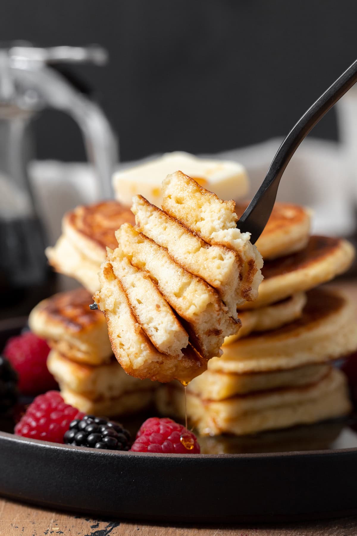 A bite of greek yogurt pancakes on a fork. The soft and fluffy inside of the pancakes shown.