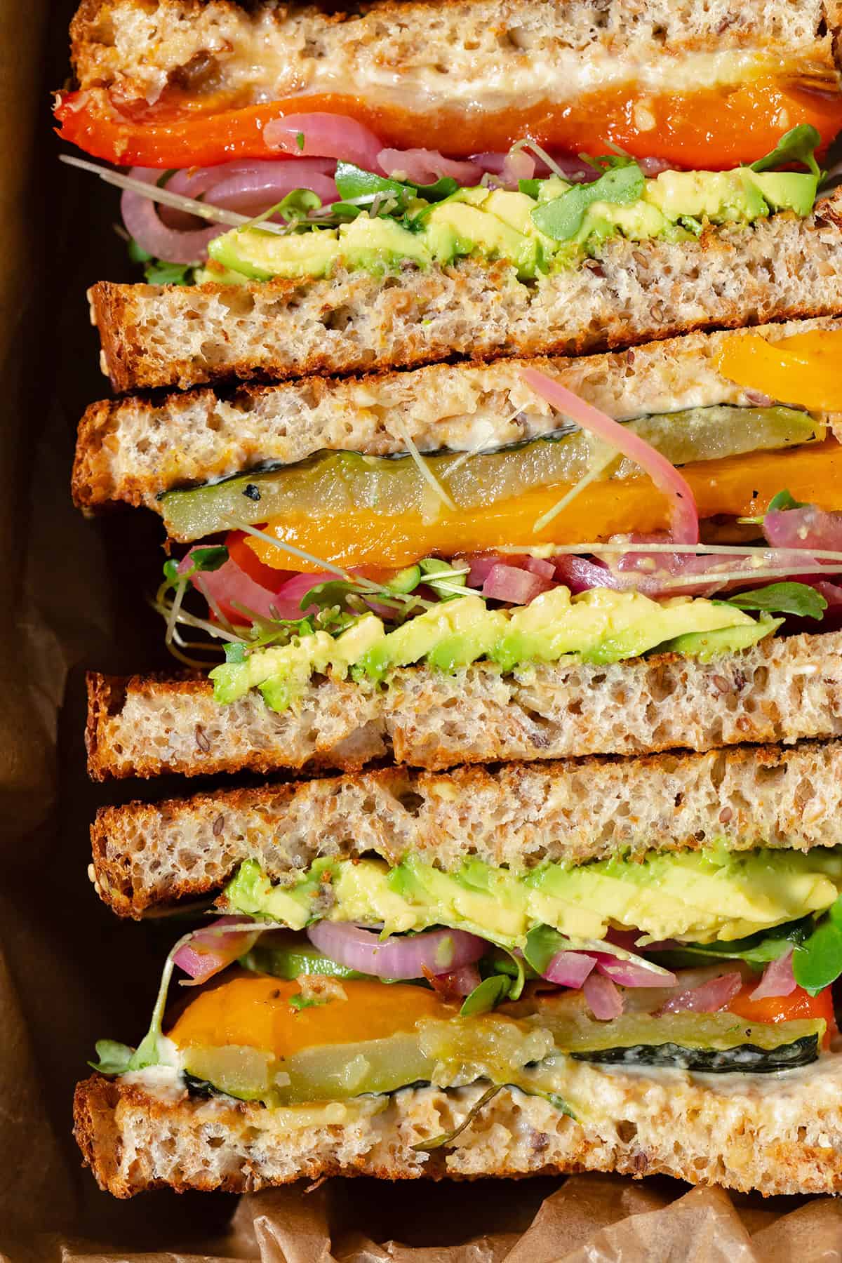 A close up of sandwiches ready to eat. Cut and laid out cut side up.