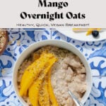 Mango overnight oats in a white bowl on a blue tile background. Mango on a white plate in the top right corner. Title in photo.