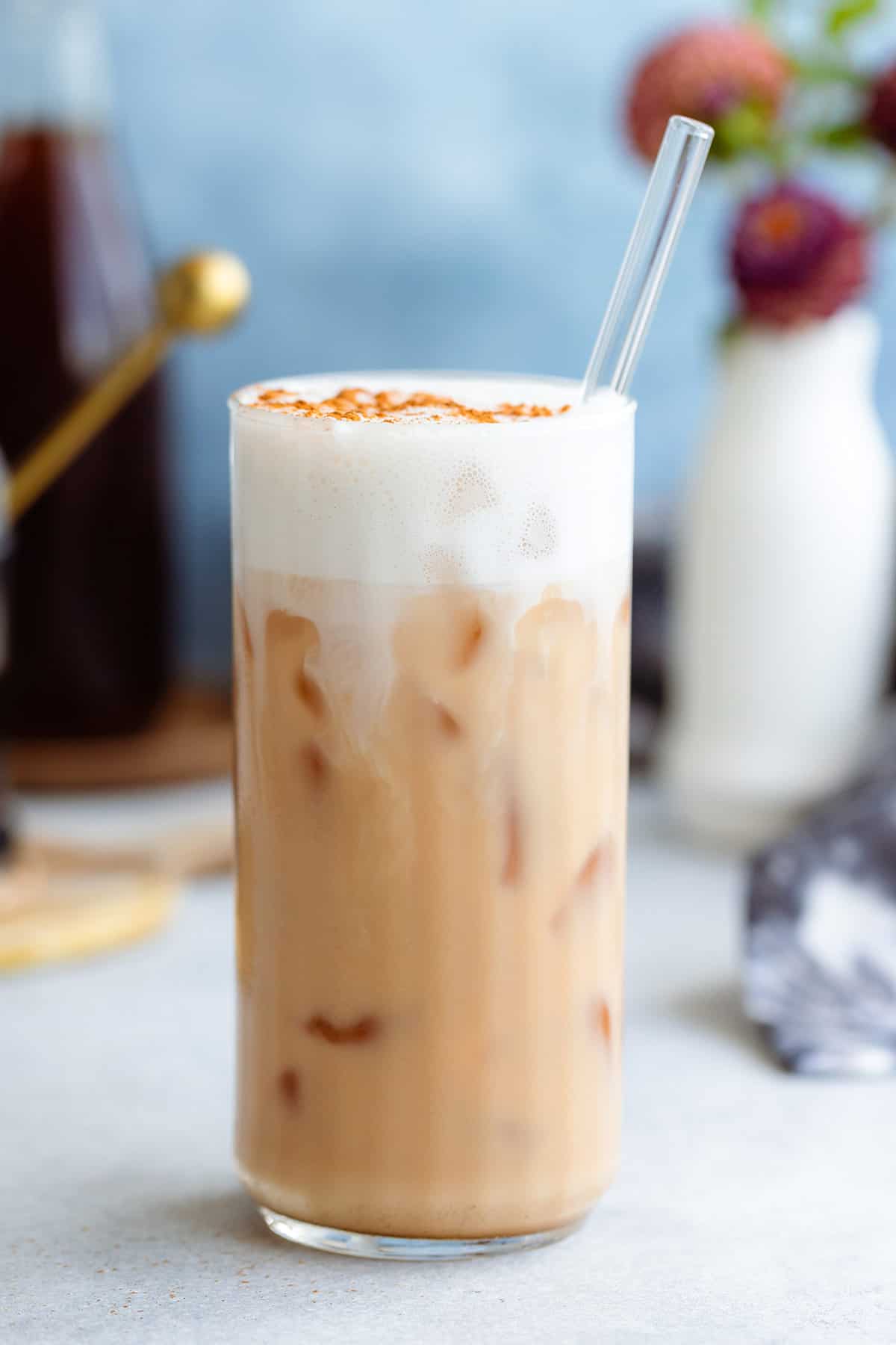 London Fog Tea Latte in a tall glass with frothy milk on top.