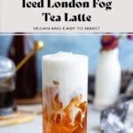 Earl grey in a tall glass with ice and frothy milk on top slowly blending together.