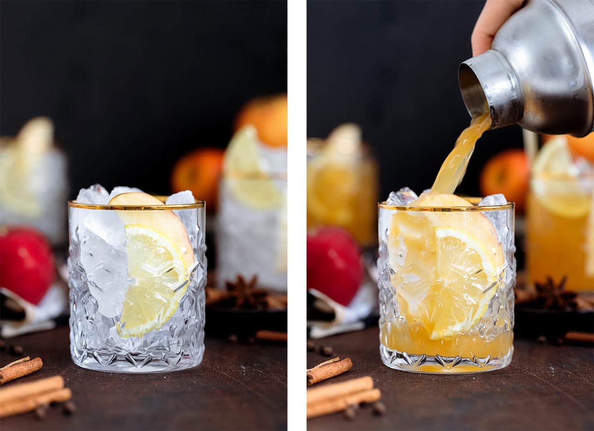 Bourbon cocktail being poured over ice into a glass with a gold rim on a dark wooden background.