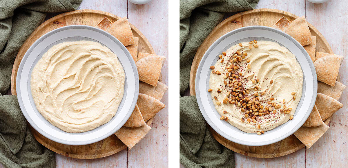 Hummus in a shallow grey bowl topped with pine nuts and sumac.