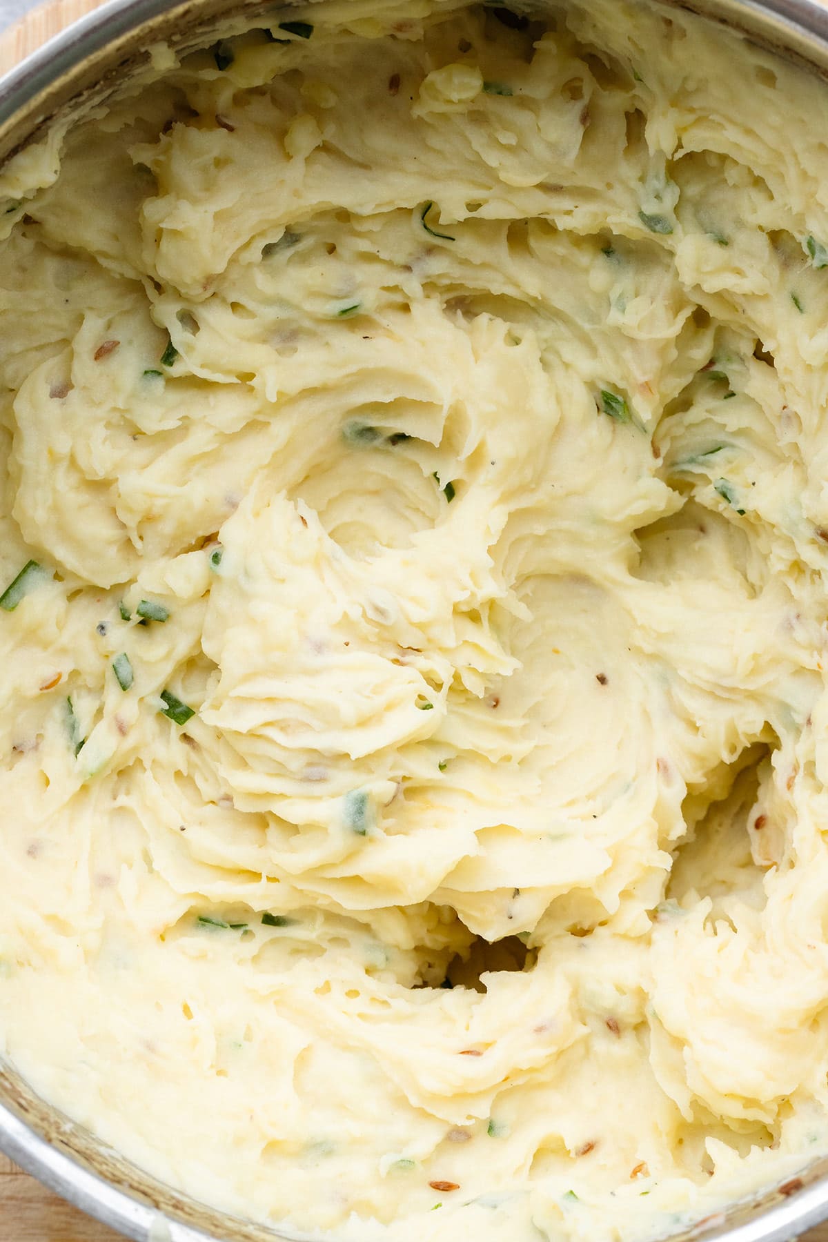 A close up of roasted garlic mashed potatoes in a large pot.