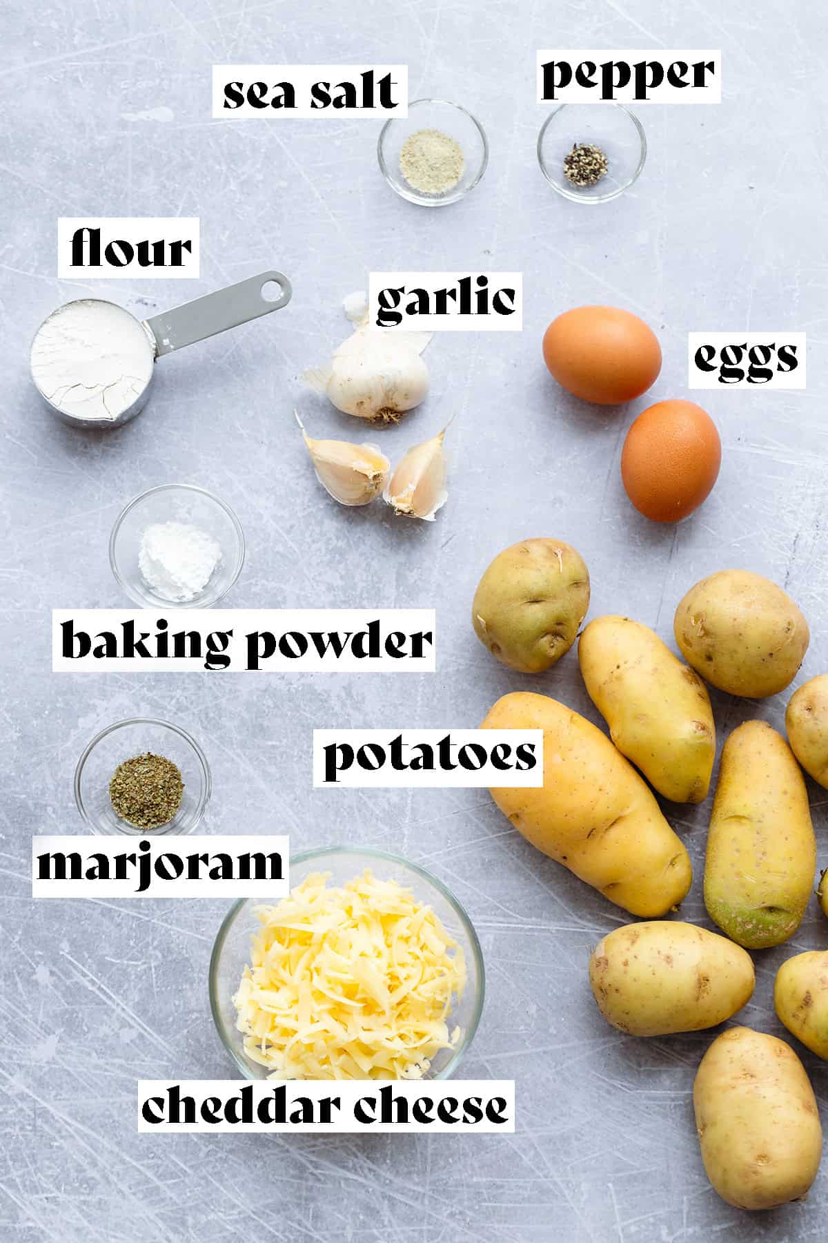 Ingredients for hash brown waffles laid out on a scratched metal surface.