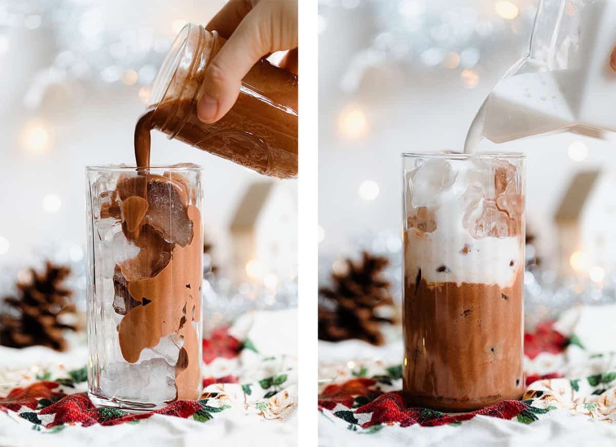 Chocolate milk being poured into a tall glass over ice.