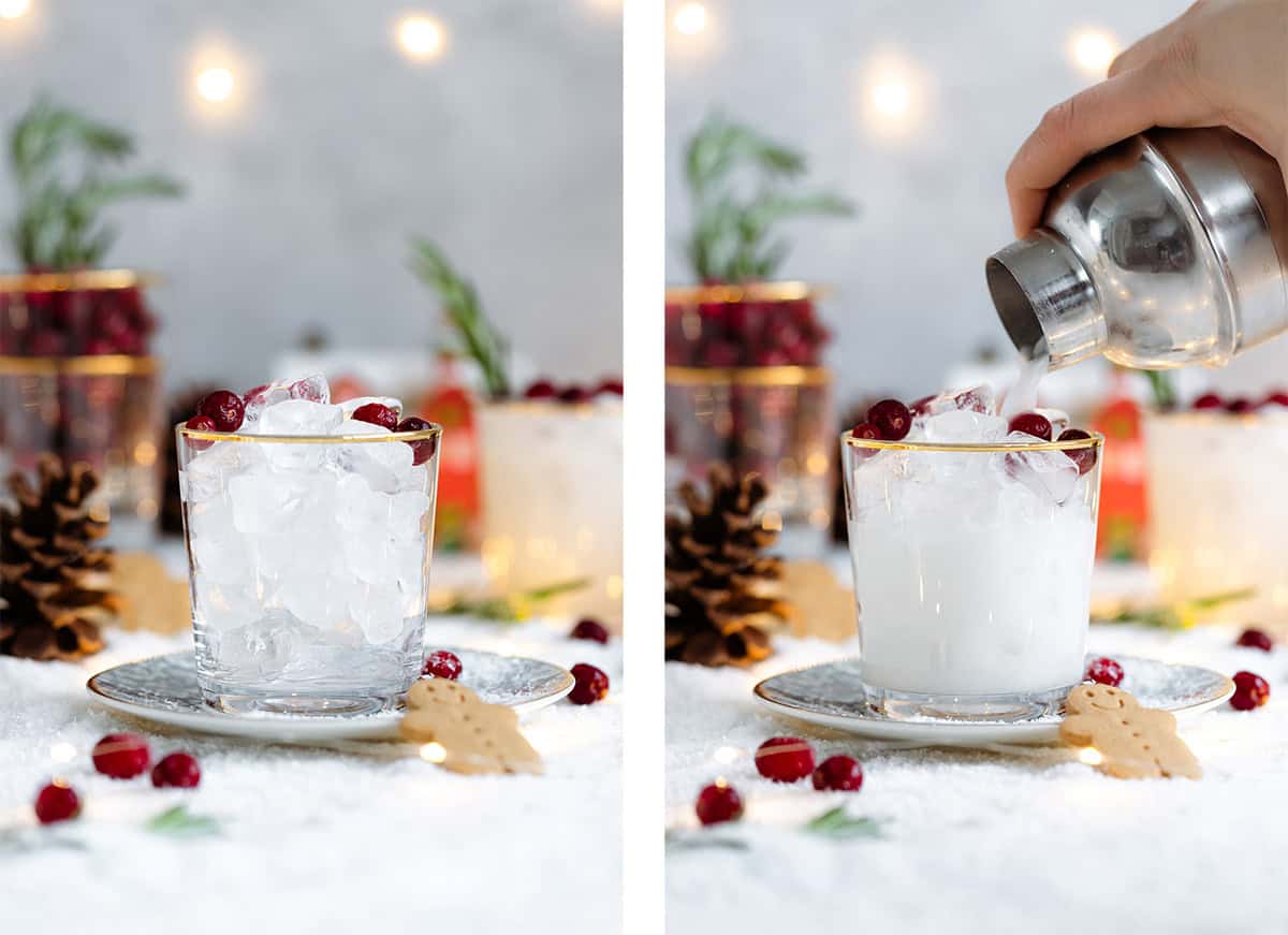 White margarita in a short glass with a gold rim, garnished with fresh cranberries, and rosemary spring.