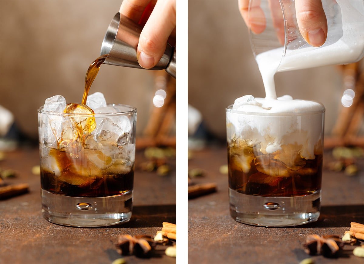 A hand pouring kahlua and frothy milk over ice into a short glass.