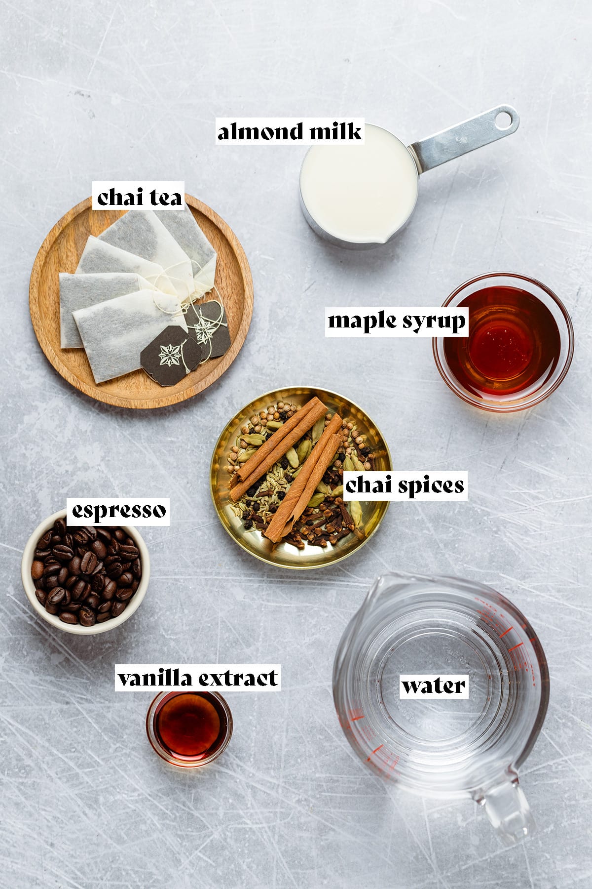 Ingredients for dirty chai latte laid out including spices, teabags, and coffee beans.