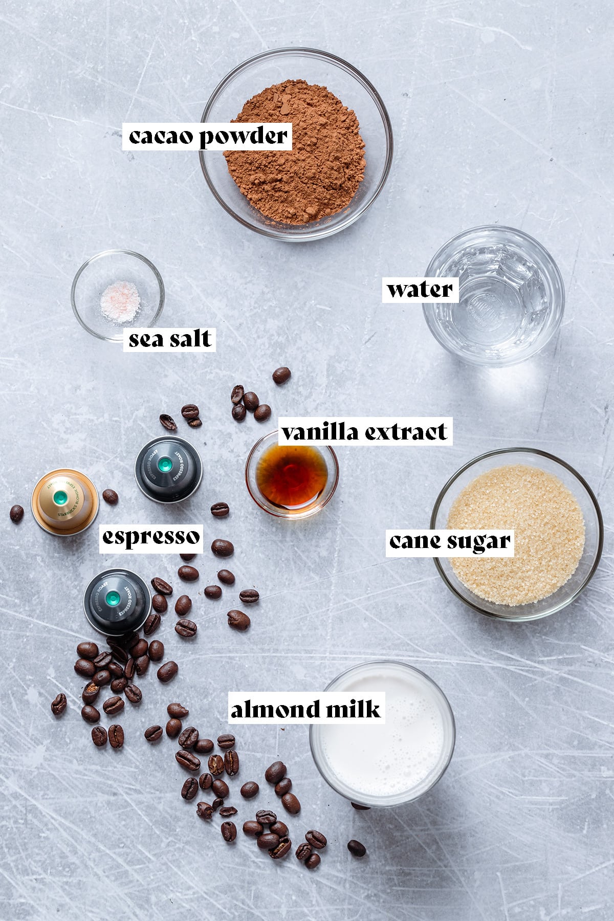 Ingredients for Iced Chocolate Shaken Espresso like coffee, cacao, and sugar all laid out.