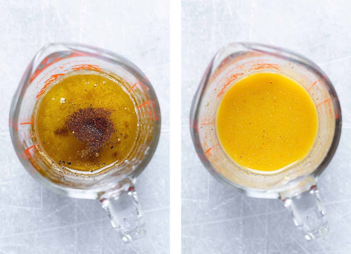 Chipotle dressing in a glass measuring cup on a grey background.